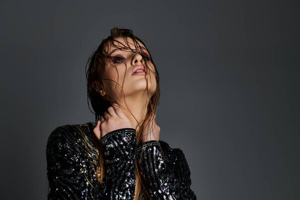 Young stylish woman in trendy attire with wet hair.