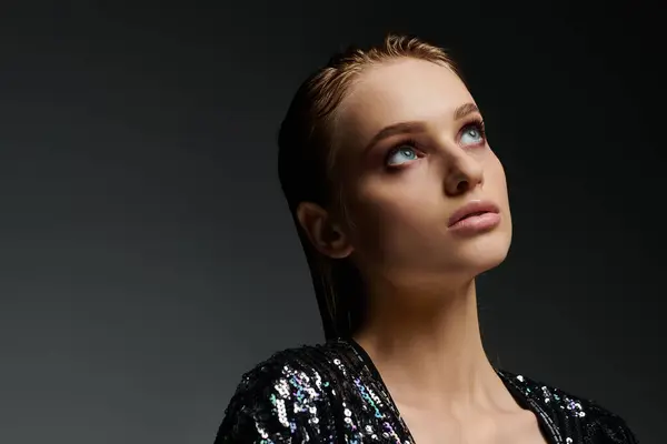 stock image Young woman with striking eyes and a black top, showcasing her wet hair.