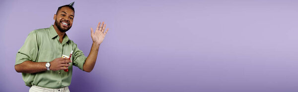 Young man with braces stands confidently against a vibrant purple wall, exuding joy and positivity.
