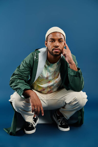 African American man in a vibrant green jacket and white pants striking a pose.