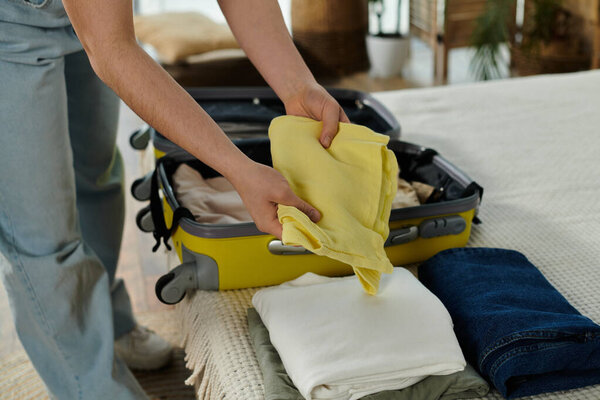 Young woman meticulously packing suitcase, preparing for a vacation and trip.
