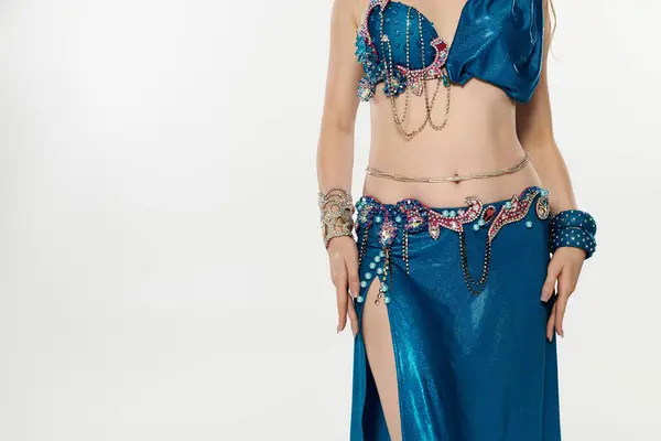 stock image Elegantly dancing, a woman captivates in a stunning blue belly dance costume.