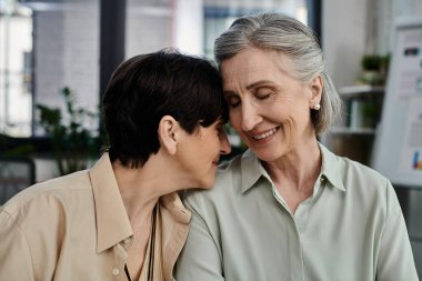 Two women sharing a tender hug. clipart