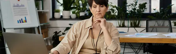 stock image Woman focused, working on laptop.