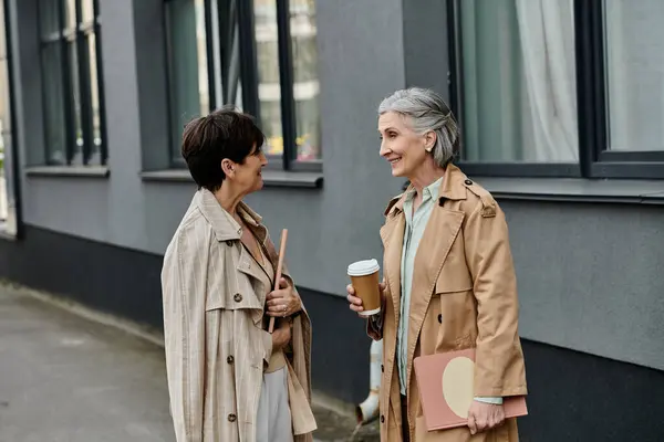 stock image Two lovely lesbians walk gracefully together to their office.