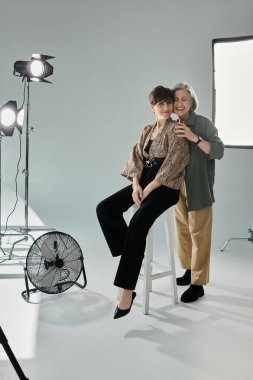 A middle-aged women styled for a photoshoot, a heartfelt hug of lesbian couple clipart