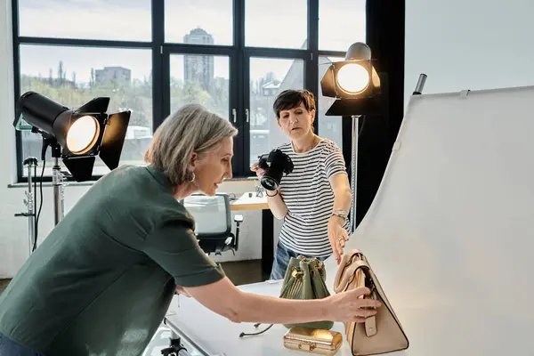 stock image Woman takes photo of bags in modern photo studio.