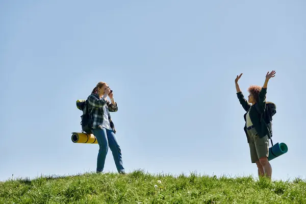 stock image A lesbian couple enjoys a sunny day hiking together, taking in the beautiful views and enjoying each others company.