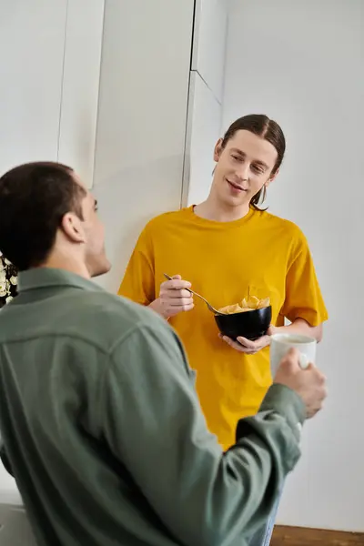 stock image A young gay couple enjoys a casual morning together in their modern apartment.