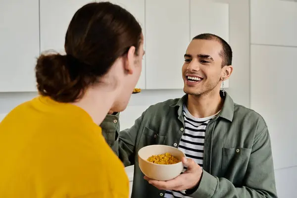 stock image A young gay couple enjoys a casual breakfast together in their modern apartment.