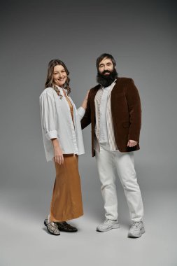 Bir çift portre için poz veriyor, beyaz gömlekli ve kahverengi etekli kadın, kahverengi ceketli ve beyaz pantolonlu adam..