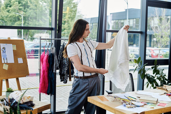 A young gay man in his atelier, examining a garment hes restoring, showcasing his dedication to sustainable fashion and giving discarded clothing new life.