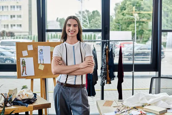 stock image A young man stands proudly in his DIY clothing restoration atelier, ready to give new life to discarded garments.