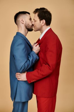 Two men in dapper suits stand close, sharing a tender moment. clipart