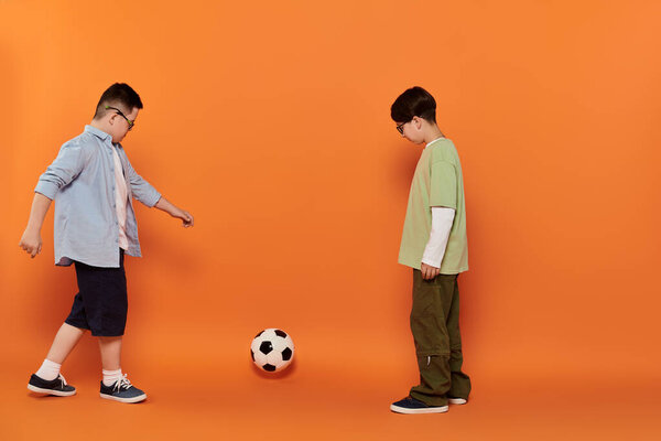 Two boys, one with Down syndrome, play soccer.