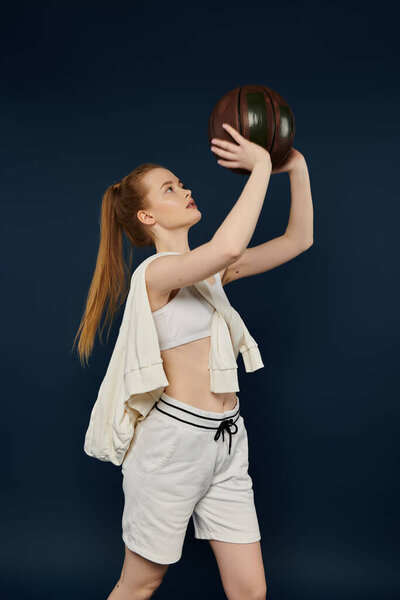 Young woman gracefully holds basketball against vibrant backdrop.