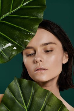 A close-up portrait of a woman posing with large green leaves. clipart