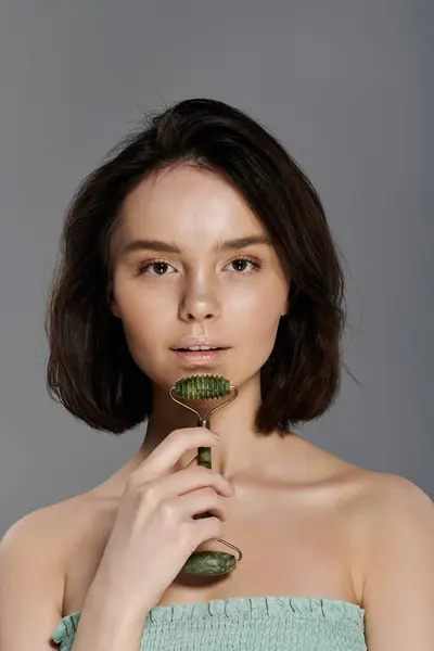 stock image Woman with jade roller finds tranquility in self-care.