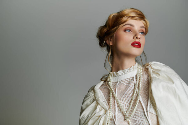 A young woman in a white lace blouse with pearl necklaces, gazing upwards.