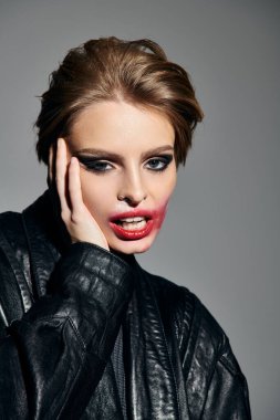 A woman with smudged makeup and a rebellious attitude poses confidently in a black leather jacket. clipart