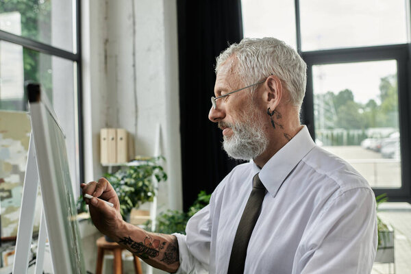 A mature man with a beard and glasses teaches an online class from his home office.