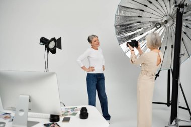 A photographer captures a portrait of her partner in a studio setting, bathed in soft lighting. clipart