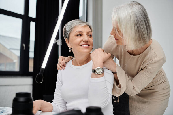 A loving couple in a studio, one taking photos while the other models.