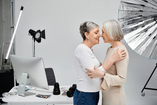 A couple poses for a photo shoot in a studio setting.