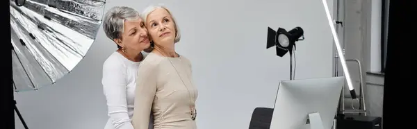 stock image A loving lesbian couple poses for a photograph in a studio setting.