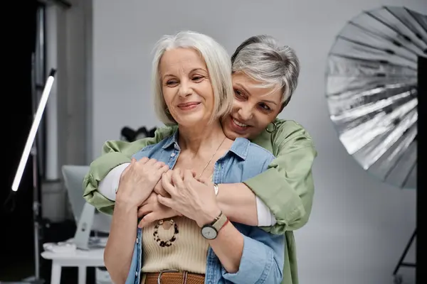 stock image Two mature women, lgbt couple, embrace in a photo studio