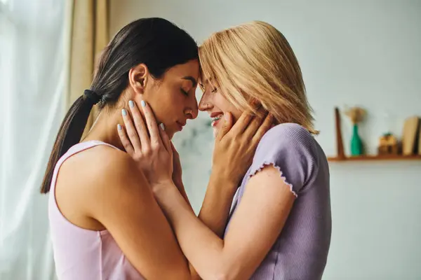 stock image A happy lesbian couple embraces each other in a cozy home.