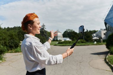 A teacher records a vlog in a campus setting. clipart