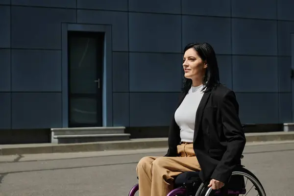 stock image A woman in a wheelchair smiles confidently as she looks towards the horizon.