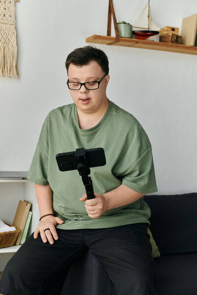 A man with Down syndrome records himself enjoying a creative moment at home.