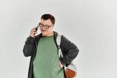 Down sendromlu neşeli bir adam telefonundan mutluluk saçıyor..