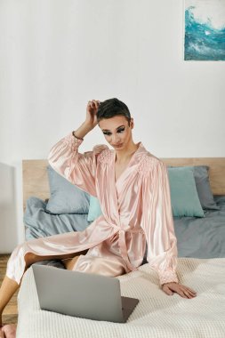 A vibrant young drag queen connects with an online audience in stylish sleepwear. clipart