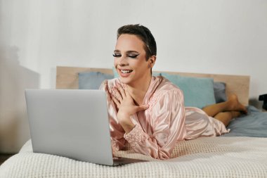 An attractive drag queen enjoys a lively online interaction. clipart