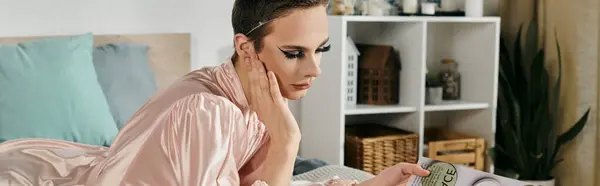 stock image An attractive drag queen relaxes with grace in a stylish bedroom environment.