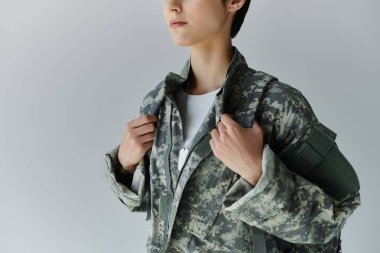 Kamuflajlı bir asker hizmete hazırlanıyor.