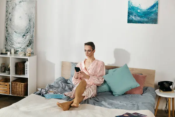 stock image A captivating drag queen enjoys a moment of relaxation while checking her phone.