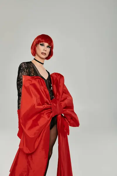 stock image A fabulous young drag queen exudes confidence in striking red attire.