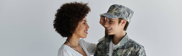 A young couple embraces tenderly in a studio, celebrating love before the soldier service.