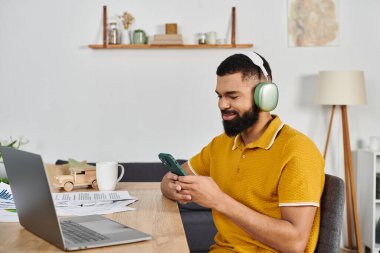 Relaxed man connects with technology while enjoying his cozy home environment. clipart