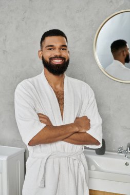 Smiling man enjoying leisure time in a stylish, serene bathroom environment. clipart