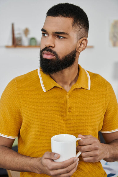 A stylish man savors his coffee while contemplating his day.