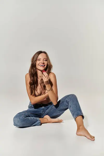 stock image A young woman exudes confidence while playfully enjoying a moment.