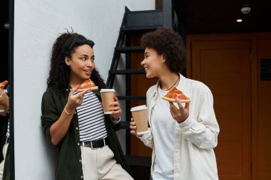 İki mutlu kadın pizzanın ve kahvenin tadını çıkarıyor. Kahkahalarını ve aşklarını otel odalarında paylaşıyorlar..