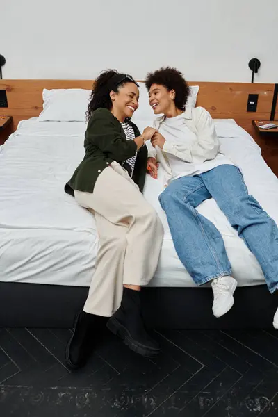 Stock image A happy couple shares laughter and love while enjoying their hotel room retreat.