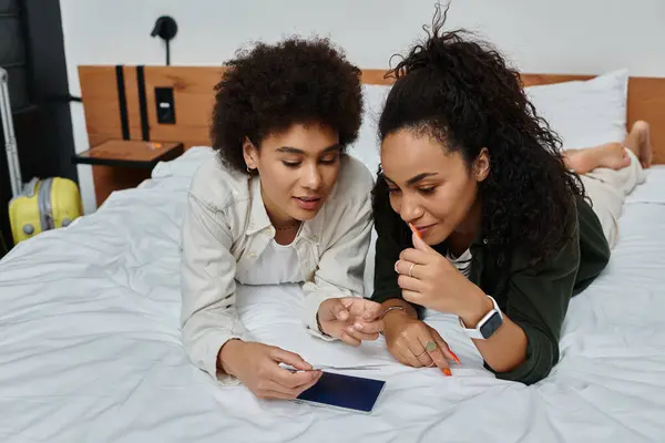 stock image A happy couple relaxes on the bed, excitedly planning their adventures together.