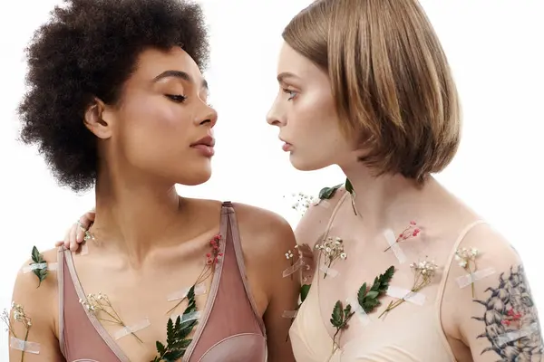 stock image Two women share a tender moment adorned with delicate flowers.